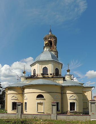 Yellow Orthodox Church Under Renovation Against Blue Sky