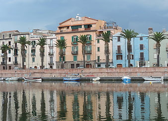 Colorful Mediterranean harbor with palm trees and boats