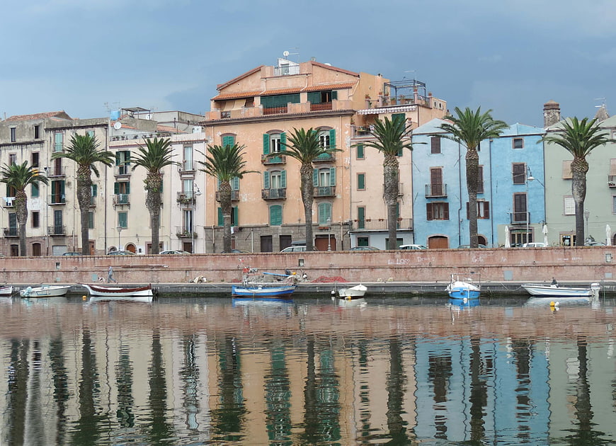 Colorful Mediterranean harbor with palm trees and boats
