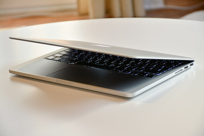 Silver laptop on white table with blurred background