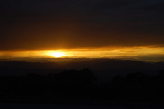 Dramatic Golden Sunset Over Silhouetted Mountain Ranges