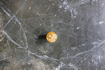Top view of latte art coffee on scratched concrete background