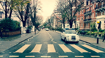 Classic London Taxi on Zebra Crossing in Urban Street