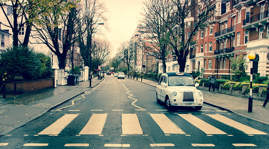 Classic London Taxi on Zebra Crossing in Urban Street