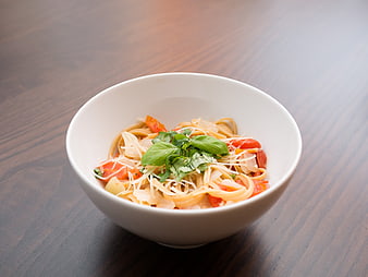 Fresh Pasta with Tomatoes and Basil in White Bowl
