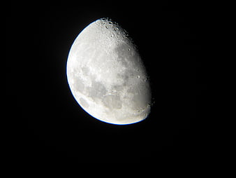Detailed Crescent Moon with Craters Against Black Night Sky
