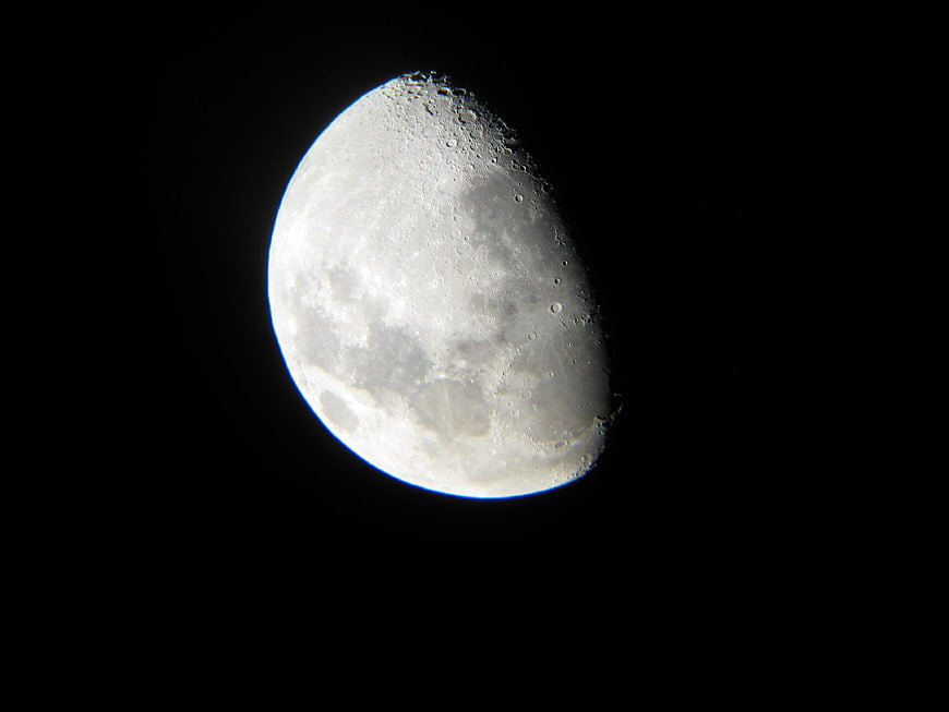 Detailed Crescent Moon with Craters Against Black Night Sky
