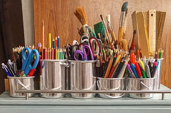 Organized Art Supplies in Metal Pots on Shelf