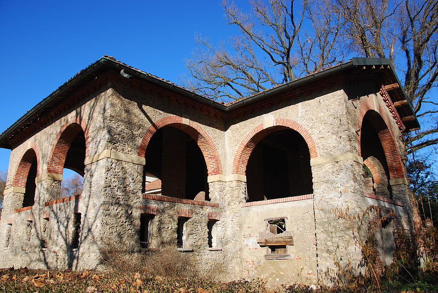 Historic stone mill building with brick arches in Monza park