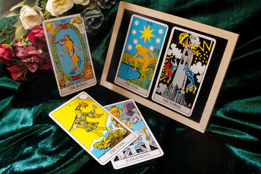Rider-Waite Tarot Cards Arranged on Green Velvet with Flowers