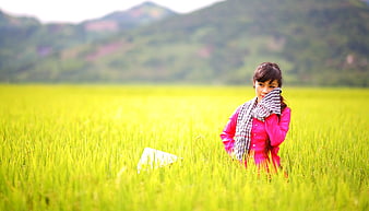 Young Asian Woman in Pink Standing in Green Rice Paddy Field