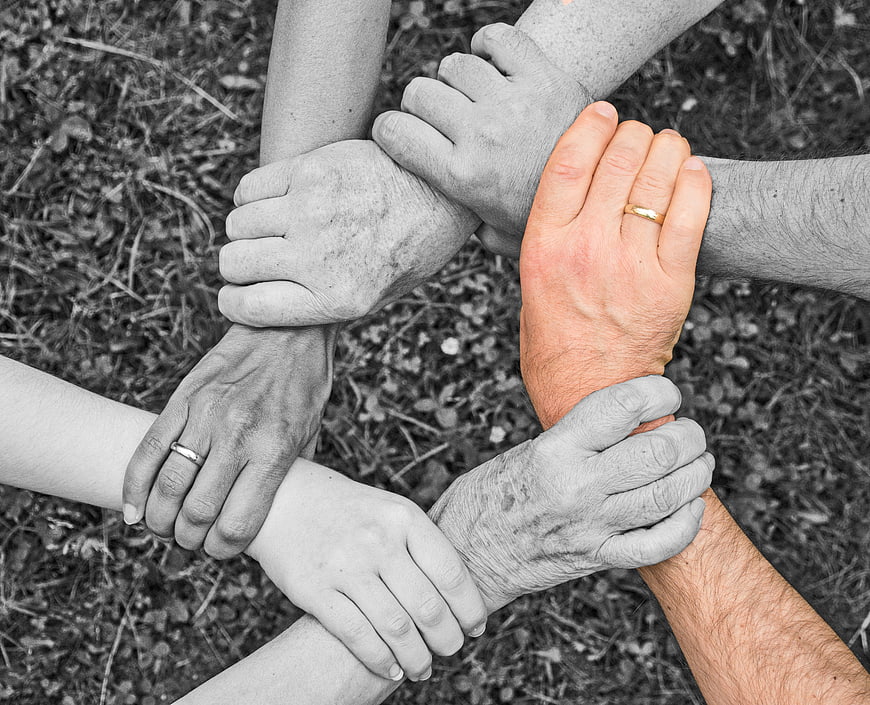 Selective Color Hands Circle Symbolizing Unity and Teamwork