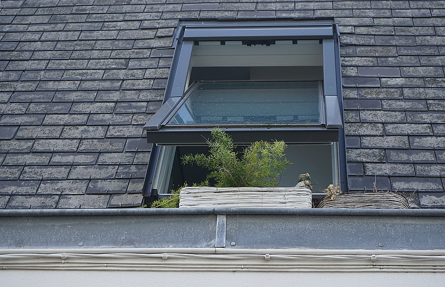 Open Dormer Window with Plants on Slate Roof