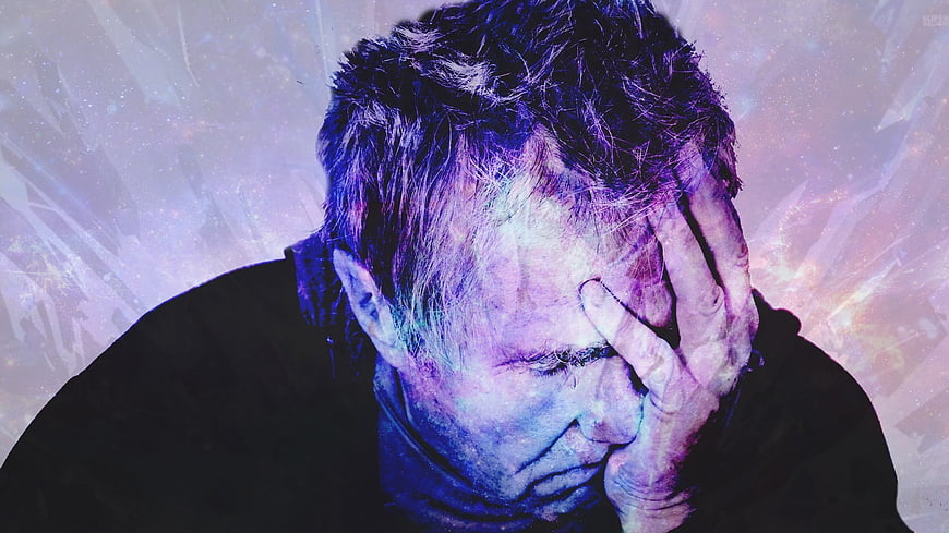 Stressed Man Holding Head In Pain Against Cosmic Background