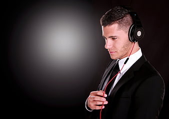 Businessman in Suit Listening to Music with Headphones