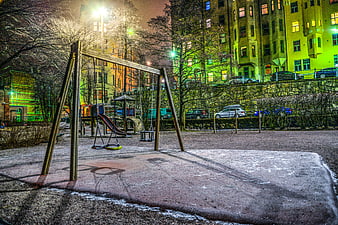 Empty Urban Playground at Night with Vibrant Green Lighting
