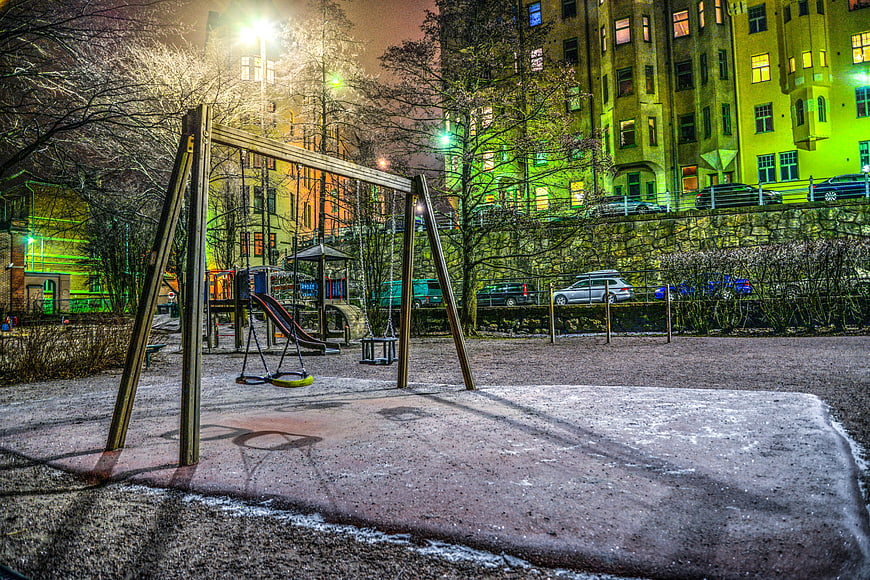 Empty Urban Playground at Night with Vibrant Green Lighting