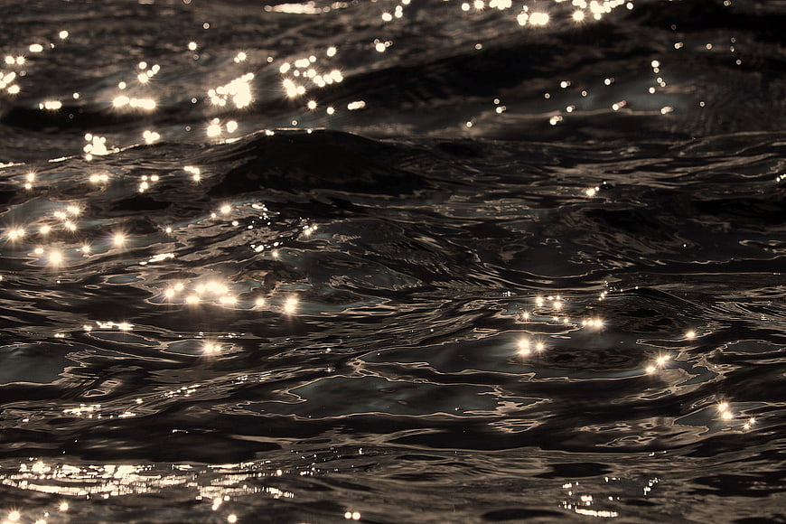 Sparkling Water Surface Texture With Golden Sunlight Reflections