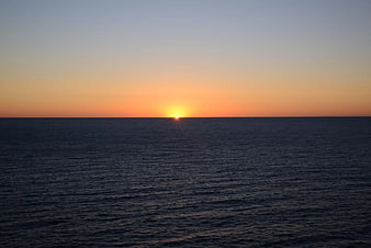 Serene Sunset Over Calm Ocean Horizon