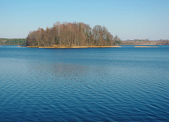 Serene Forested Island in Blue Lake Water