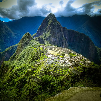 Machu Picchu ruins with Huayna Picchu mountain and dramatic clouds