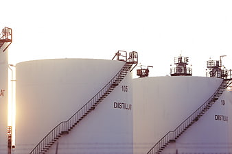 White Industrial Distillate Storage Tanks With Staircases
