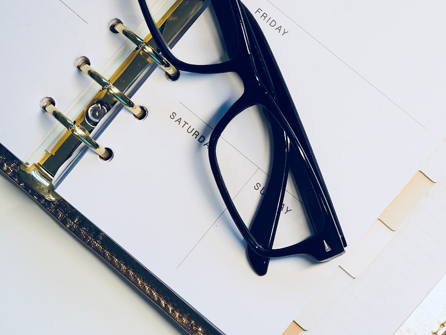 Black Glasses on Weekly Planner Calendar