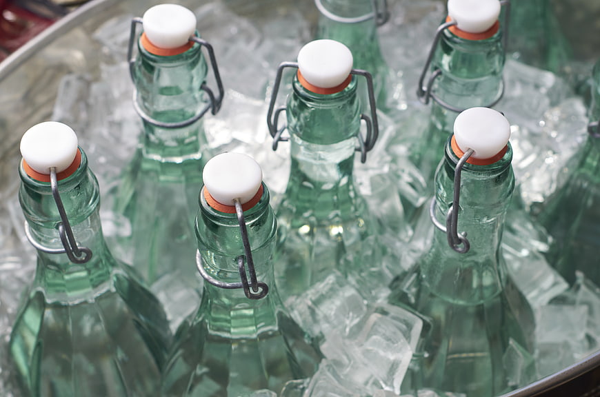 Green Glass Bottles with Swing Tops in Ice Bucket