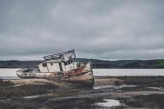 Abandoned Rusty Fishing Boat on Sandy Shore