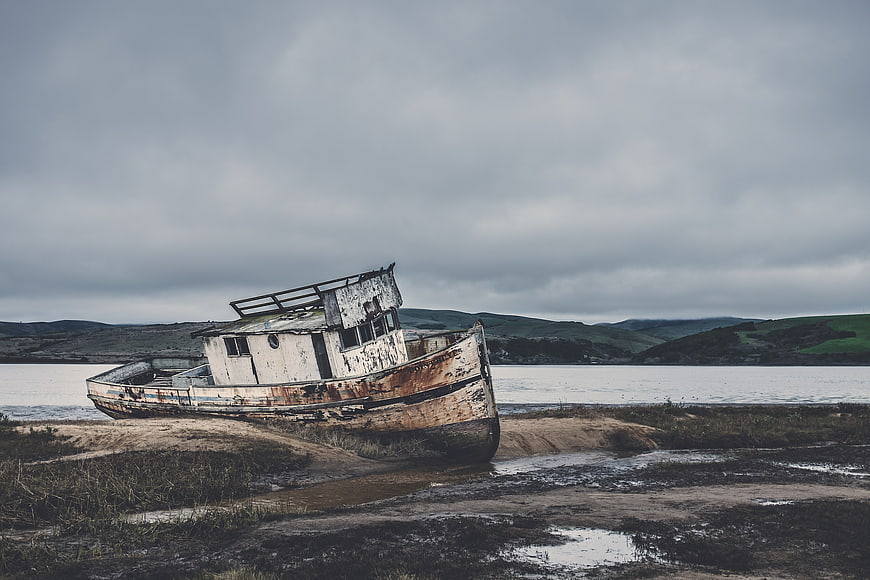 Abandoned Rusty Fishing Boat on Sandy Shore