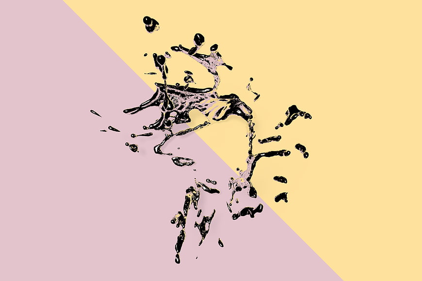 Abstract black liquid splash on pastel pink and yellow background