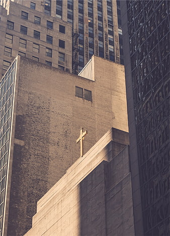 Golden Cross on Urban Church Building Amidst Skyscrapers
