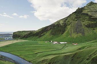 Scenic Icelandic Valley with Green Hills and Farmhouses
