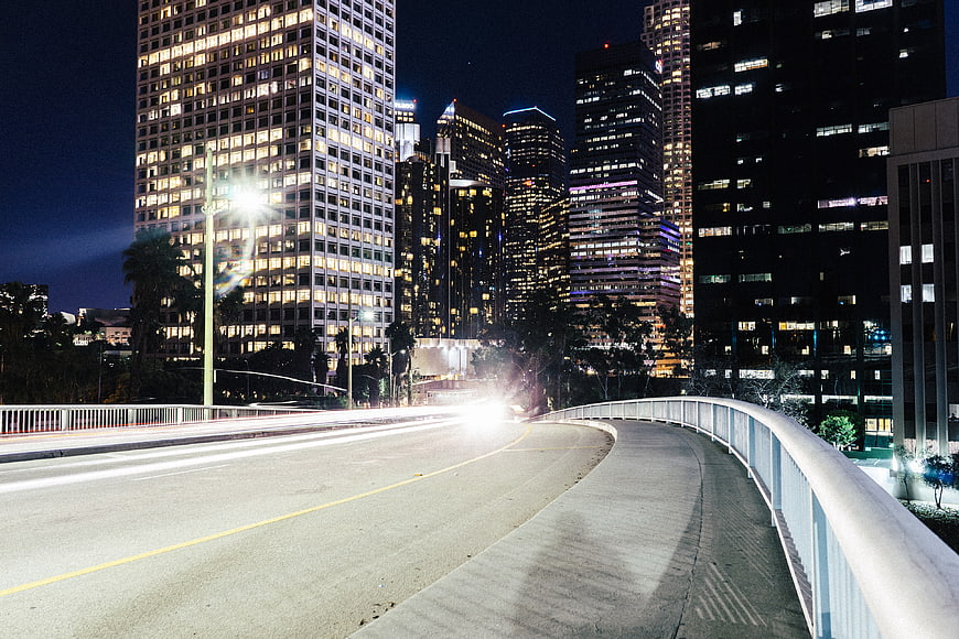 Night cityscape with light trails on a bridge