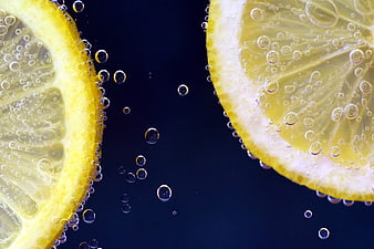 Refreshing Lemon Slices in Sparkling Water with Bubbles