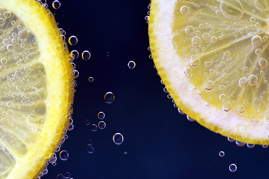 Refreshing Lemon Slices in Sparkling Water with Bubbles