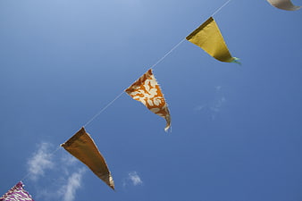 Colorful fabric bunting flags against blue sky
