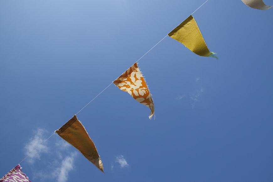 Colorful fabric bunting flags against blue sky