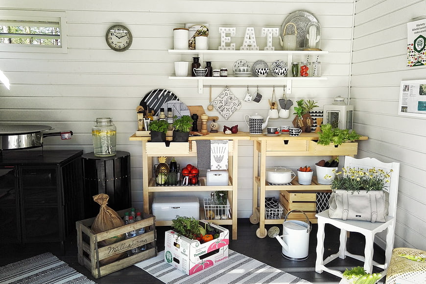 Rustic Outdoor Kitchen Setup With Wooden Shelves And Garden Decor