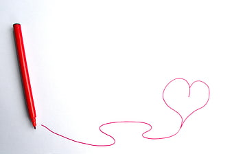 Red marker drawing a continuous line into a heart shape on white paper