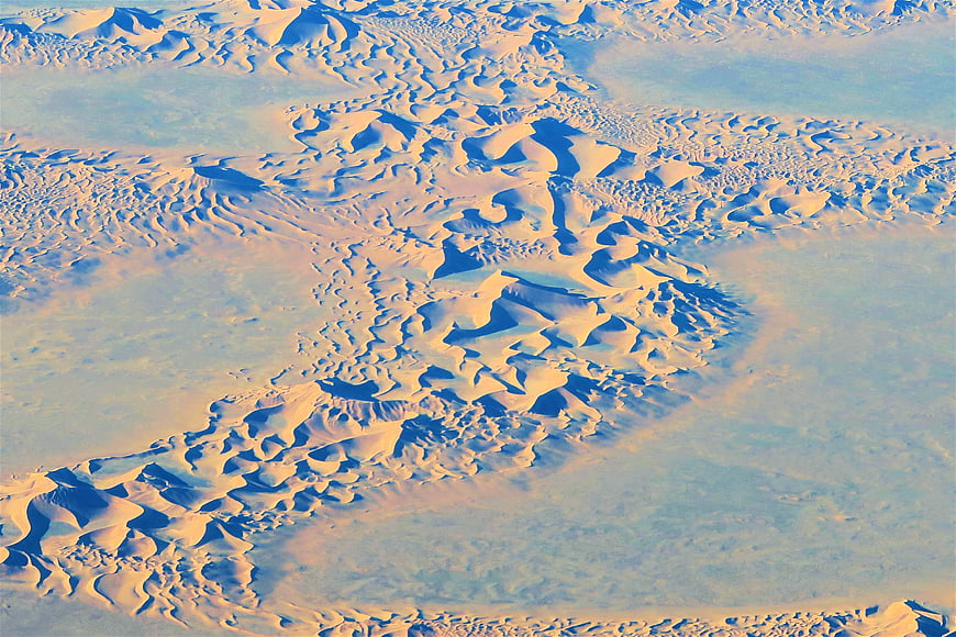 Aerial View of Sand Dunes in a Vast Desert Landscape