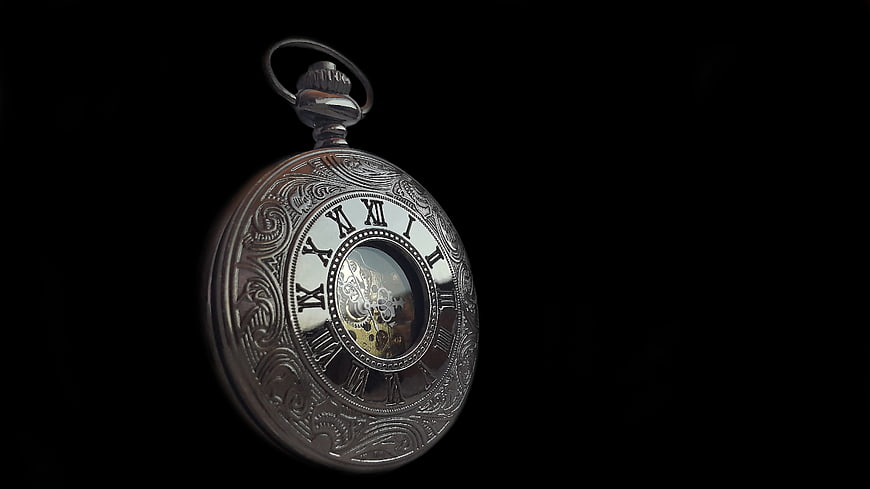 Vintage Silver Pocket Watch with Roman Numerals on Black Background