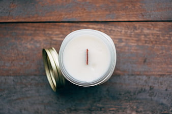 Top View of White Soy Candle in Glass Jar on Rustic Wood