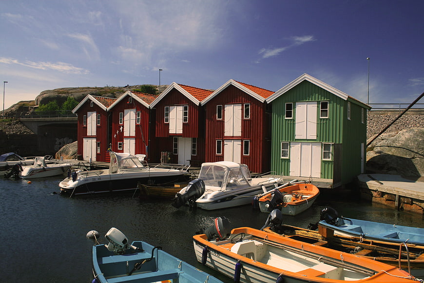 Colorful Swedish Boathouses and Boats in Harbor