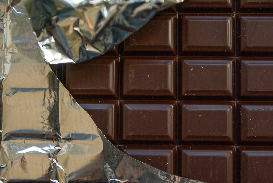 Close-up of dark chocolate bar with foil wrapper