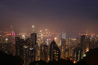 Hong Kong city skyline at night with illuminated skyscrapers and harbor lights