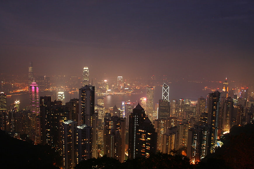 Hong Kong city skyline at night with illuminated skyscrapers and harbor lights