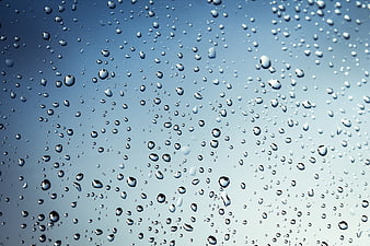 Raindrops on Glass Window Blue Background