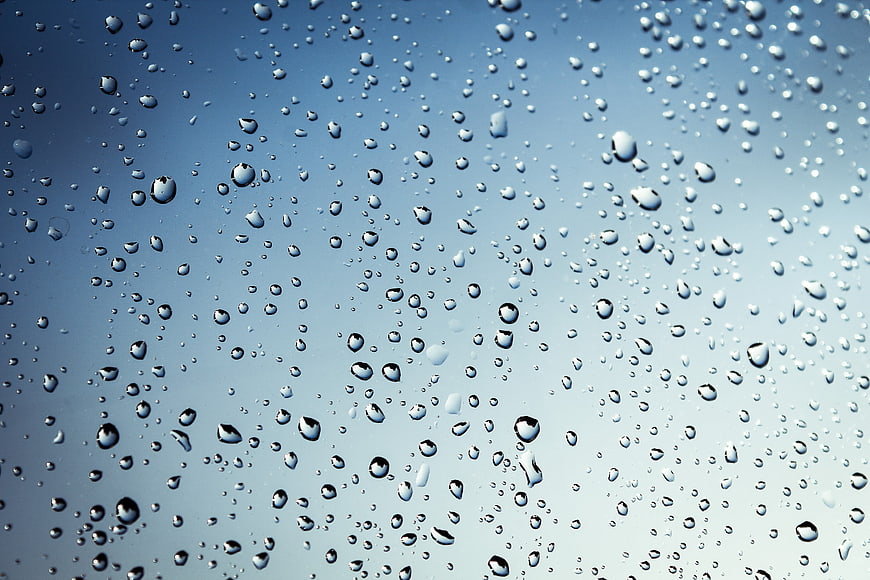 Raindrops on Glass Window Blue Background