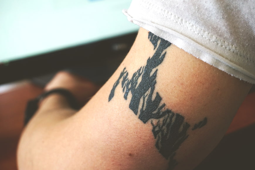 Close-up of black ink tattoo on person's arm
